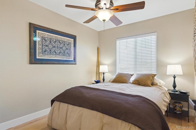 bedroom with ceiling fan and light hardwood / wood-style flooring