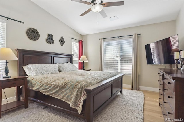 bedroom featuring vaulted ceiling, ceiling fan, and light wood-type flooring