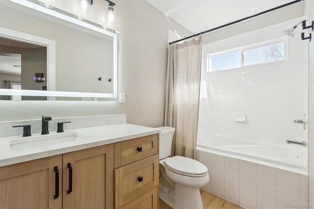 full bathroom with vanity, shower / bathtub combination with curtain, and toilet