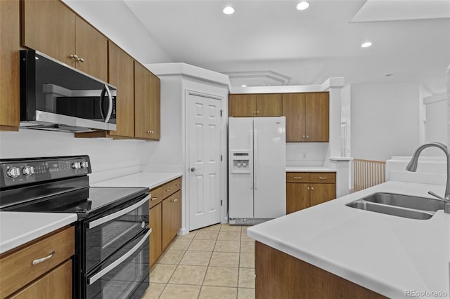 15876 Double Eagle Dr, Morrison, CO 80465 - kitchen featuring white refrigerator with ice dispenser, double oven range, brown cabinets, recessed lighting, and light countertops