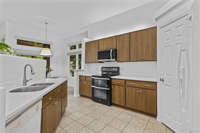 15876 Double Eagle Dr, Morrison, CO 80465 - kitchen featuring stainless steel microwave, range with two ovens, dishwasher, light countertops, and light tile patterned floors
