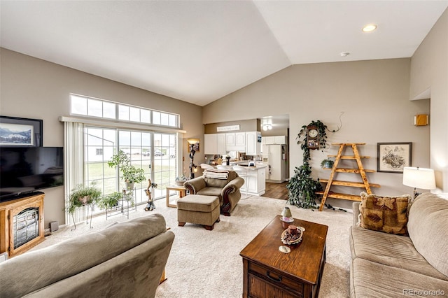 41020 US Highway 36, Bennett, CO 80102 - living area featuring high vaulted ceiling, light carpet, a fireplace, and recessed lighting