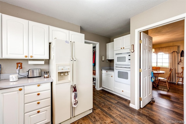 41020 US Highway 36, Bennett, CO 80102 - kitchen featuring white appliances, dark wood finished floors, white cabinets, and light countertops
