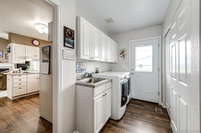 41020 US Highway 36, Bennett, CO 80102 - laundry area featuring cabinet space, independent washer and dryer, and dark wood finished floors
