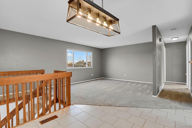 carpeted spare room with a textured ceiling