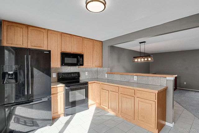 kitchen with black appliances, decorative light fixtures, kitchen peninsula, and light carpet