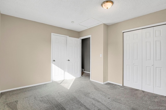 unfurnished bedroom featuring carpet floors and a textured ceiling