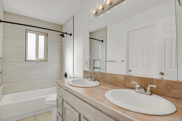 full bathroom featuring tasteful backsplash, vanity, tile patterned flooring, toilet, and tiled shower / bath