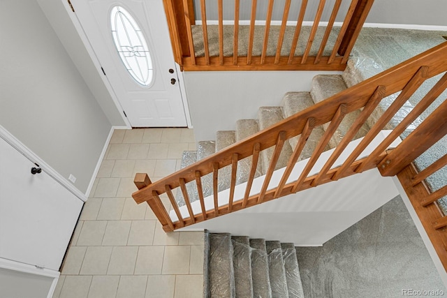 stairs featuring tile patterned flooring