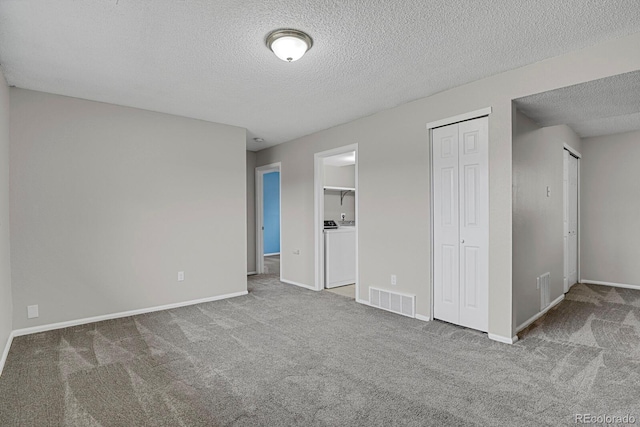 unfurnished bedroom with carpet flooring and a textured ceiling