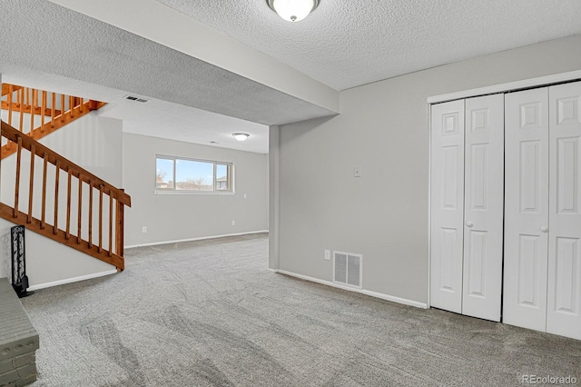 basement with a textured ceiling and carpet floors