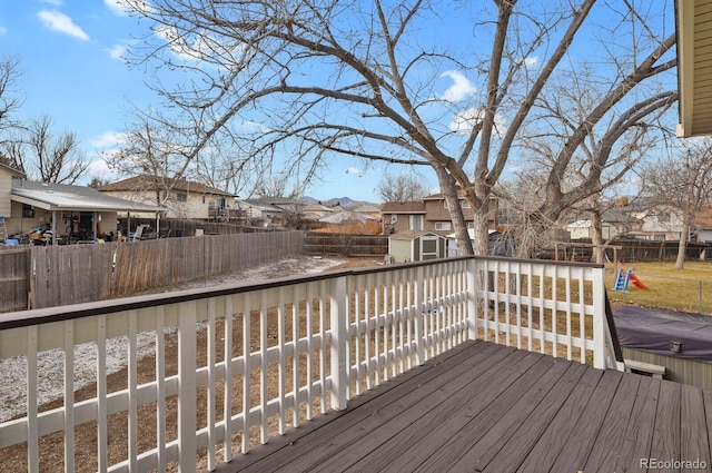 wooden terrace featuring a storage shed