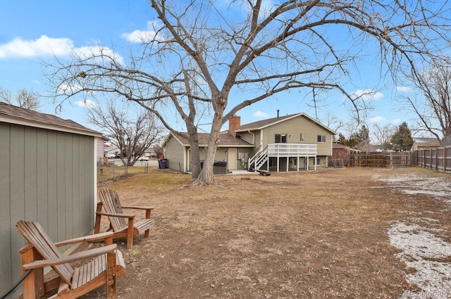 rear view of property with a wooden deck