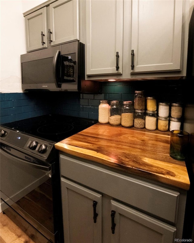 4110 Hale Pkwy Unit 5G, Denver, CO 80220 - kitchen featuring wooden counters, range with electric cooktop, and tasteful backsplash