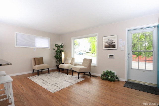 10420 Marion St, Northglenn, CO 80233 - living area featuring light wood finished floors, plenty of natural light, and baseboards