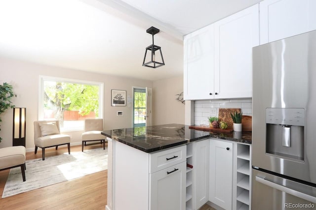 10420 Marion St, Northglenn, CO 80233 - kitchen with stainless steel fridge with ice dispenser, open shelves, white cabinets, decorative backsplash, and light wood-style flooring