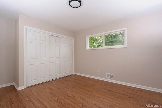 10420 Marion St, Northglenn, CO 80233 - unfurnished bedroom with baseboards, wood finished floors, and a closet