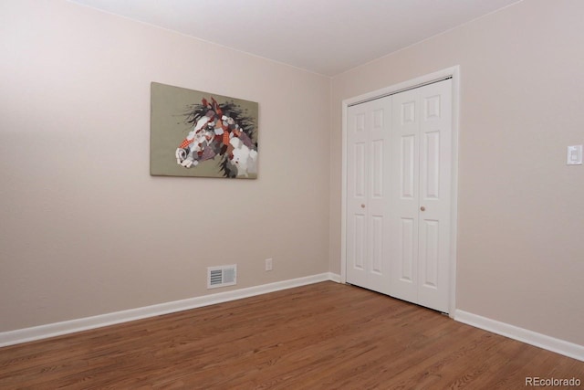 10420 Marion St, Northglenn, CO 80233 - unfurnished bedroom featuring wood finished floors, baseboards, and a closet