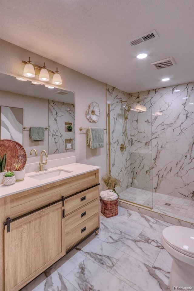 10420 Marion St, Northglenn, CO 80233 - full bath with marble finish flooring, toilet, vanity, a marble finish shower, and recessed lighting