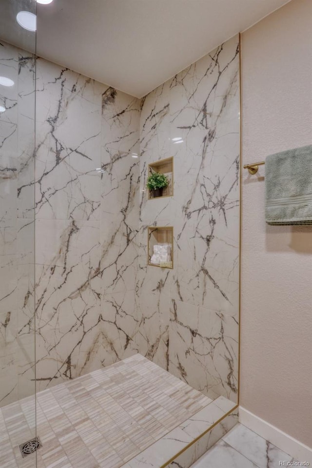 10420 Marion St, Northglenn, CO 80233 - bathroom featuring marble finish flooring, a marble finish shower, and baseboards