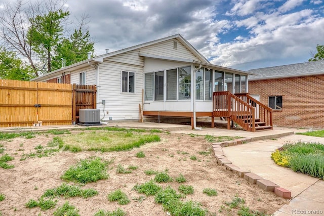 10420 Marion St, Northglenn, CO 80233 - rear view of property featuring a sunroom and central AC unit