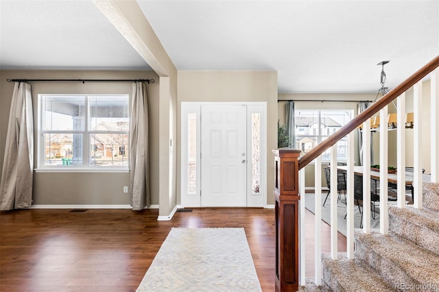 entryway with dark hardwood / wood-style floors