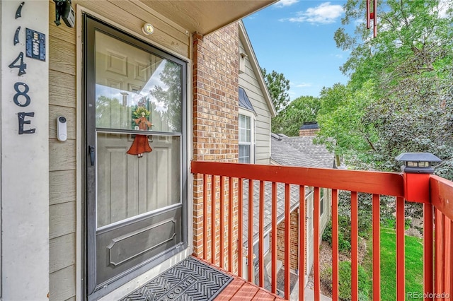 doorway to property with brick siding