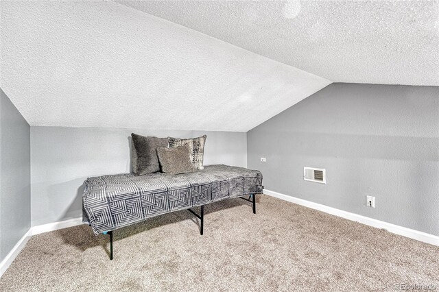 living area with visible vents, vaulted ceiling, light carpet, and baseboards