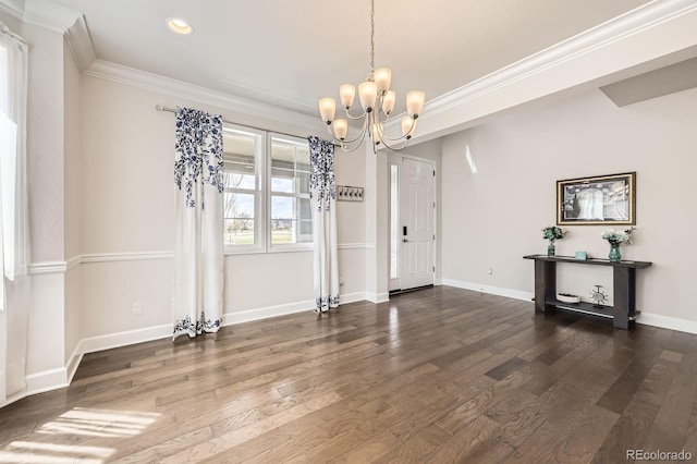 unfurnished dining area featuring baseboards, wood-type flooring, a chandelier, ornamental molding, and recessed lighting
