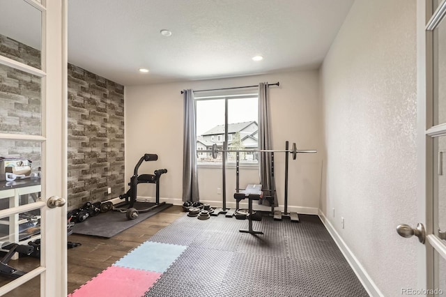 workout room with baseboards and recessed lighting