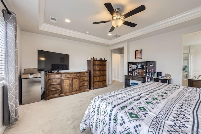 bedroom with a tray ceiling, crown molding, carpet flooring, and visible vents