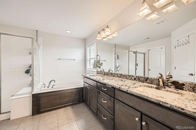 bathroom featuring a sink, tile patterned flooring, visible vents, a garden tub, and a stall shower