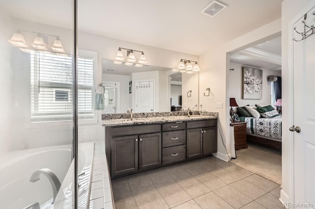 ensuite bathroom with visible vents, double vanity, a bathing tub, tile patterned floors, and ensuite bath