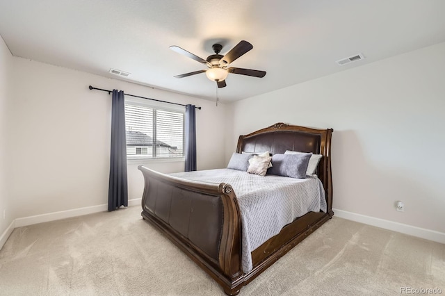 bedroom featuring baseboards, visible vents, and light carpet