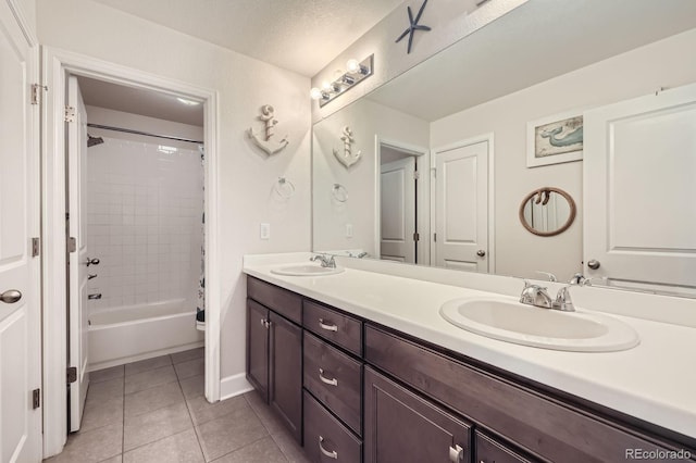 full bathroom featuring double vanity, a sink, tile patterned floors, and shower / bath combo