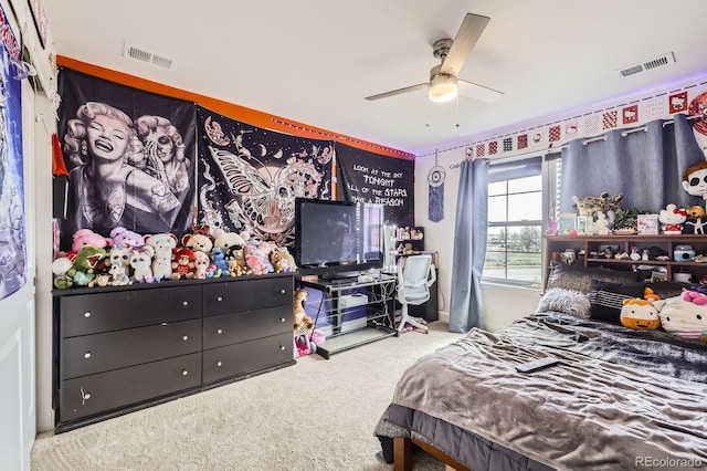 carpeted bedroom with a ceiling fan and visible vents
