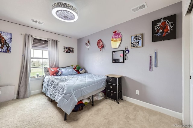 bedroom featuring baseboards, light carpet, and visible vents