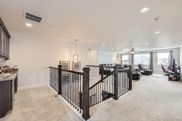 corridor with light colored carpet, baseboards, visible vents, and recessed lighting