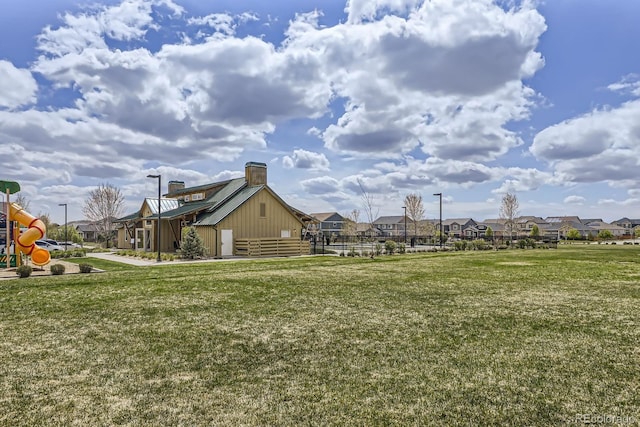 view of yard featuring a residential view and playground community