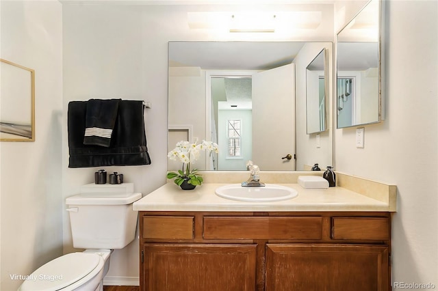 bathroom featuring vanity and toilet