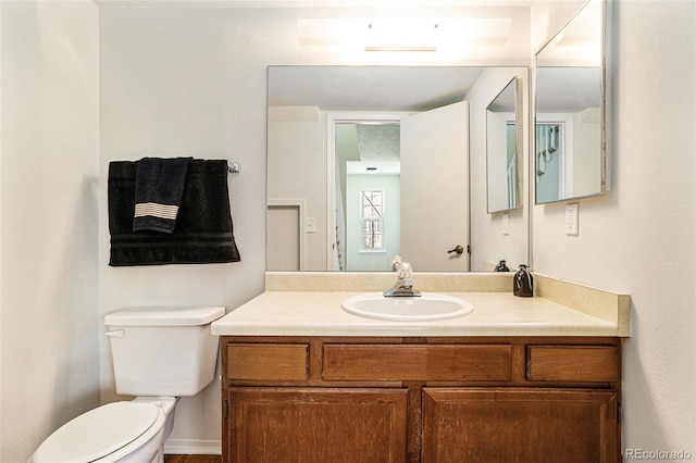 bathroom featuring vanity and toilet