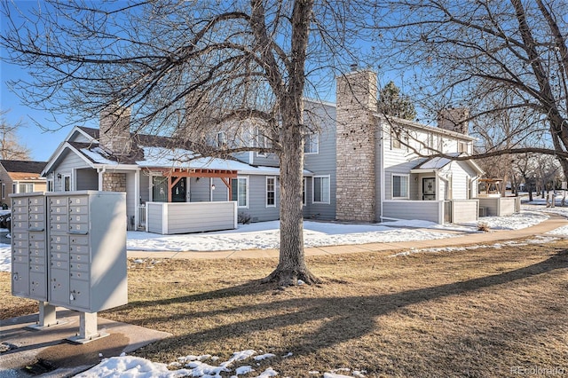 view of snow covered back of property