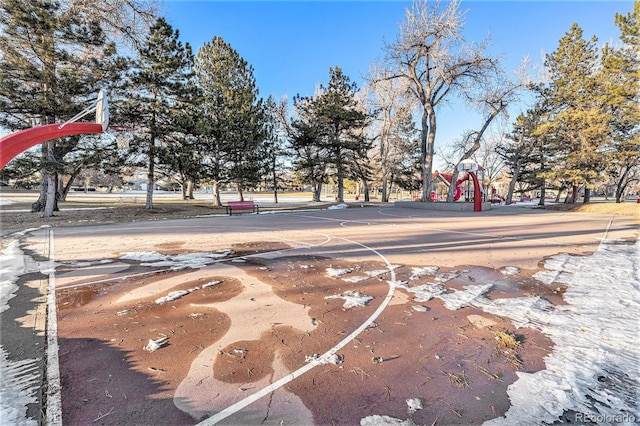 view of basketball court featuring a playground