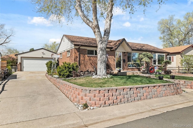 single story home with brick siding, an outbuilding, a front yard, and a detached garage