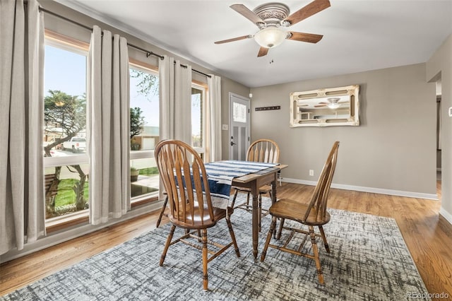 dining area with baseboards, ceiling fan, and wood finished floors