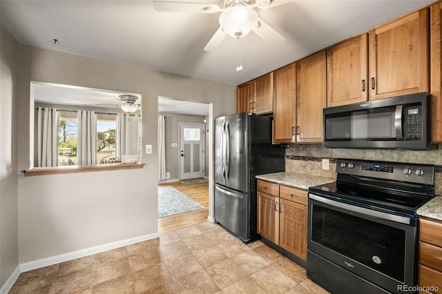 kitchen with brown cabinets, ceiling fan, stainless steel appliances, baseboards, and backsplash