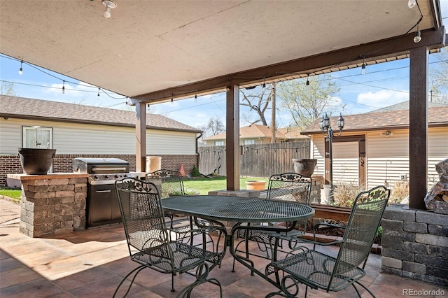 view of patio / terrace with fence, outdoor dining area, and area for grilling