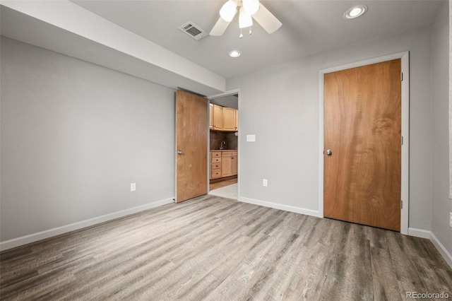 unfurnished bedroom with recessed lighting, baseboards, visible vents, and wood finished floors