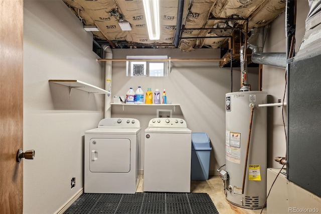 washroom featuring washing machine and dryer and gas water heater
