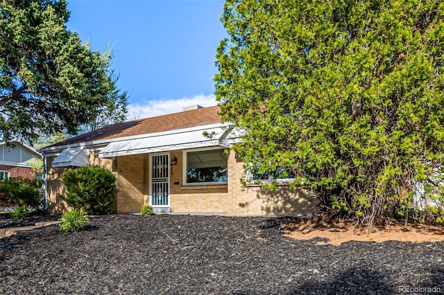 view of front of home with brick siding